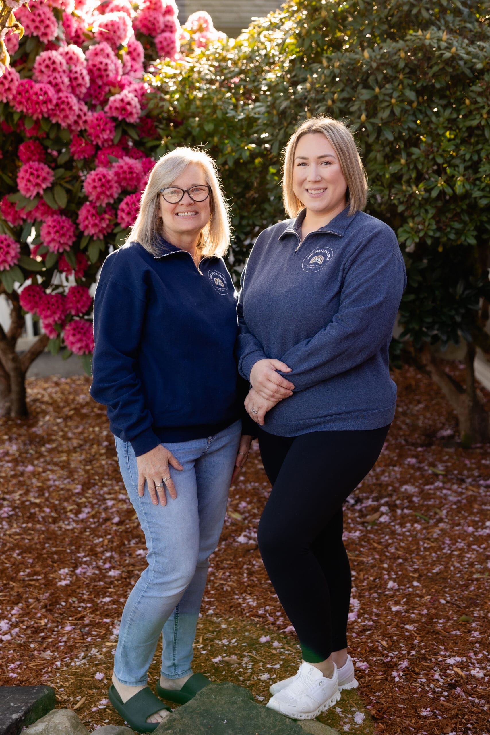 Two female teachers smiling outside in the sunshine